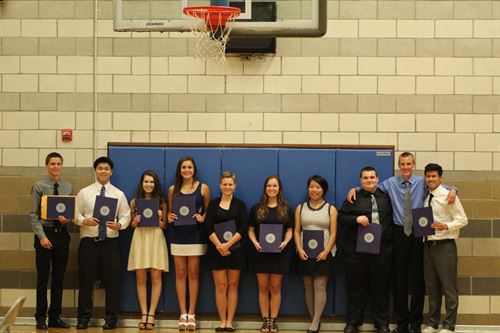 students holding awards